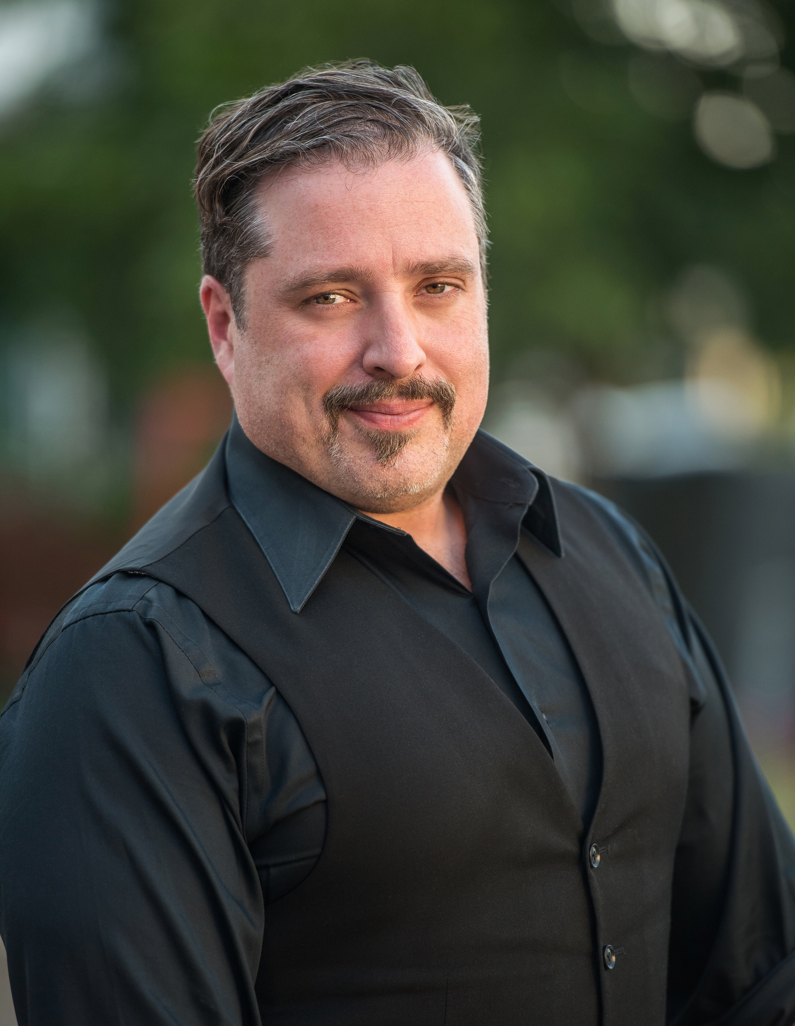 Eden CEO Bart Womack smiles in black shirt.