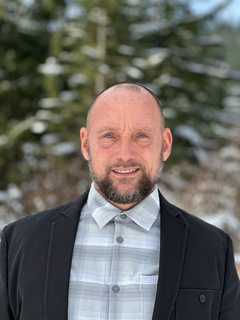 Eden VP of Manufacturing Mike Sayler smiles in suit jacket.