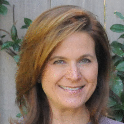 Eden board member Kim Peterson smiles.