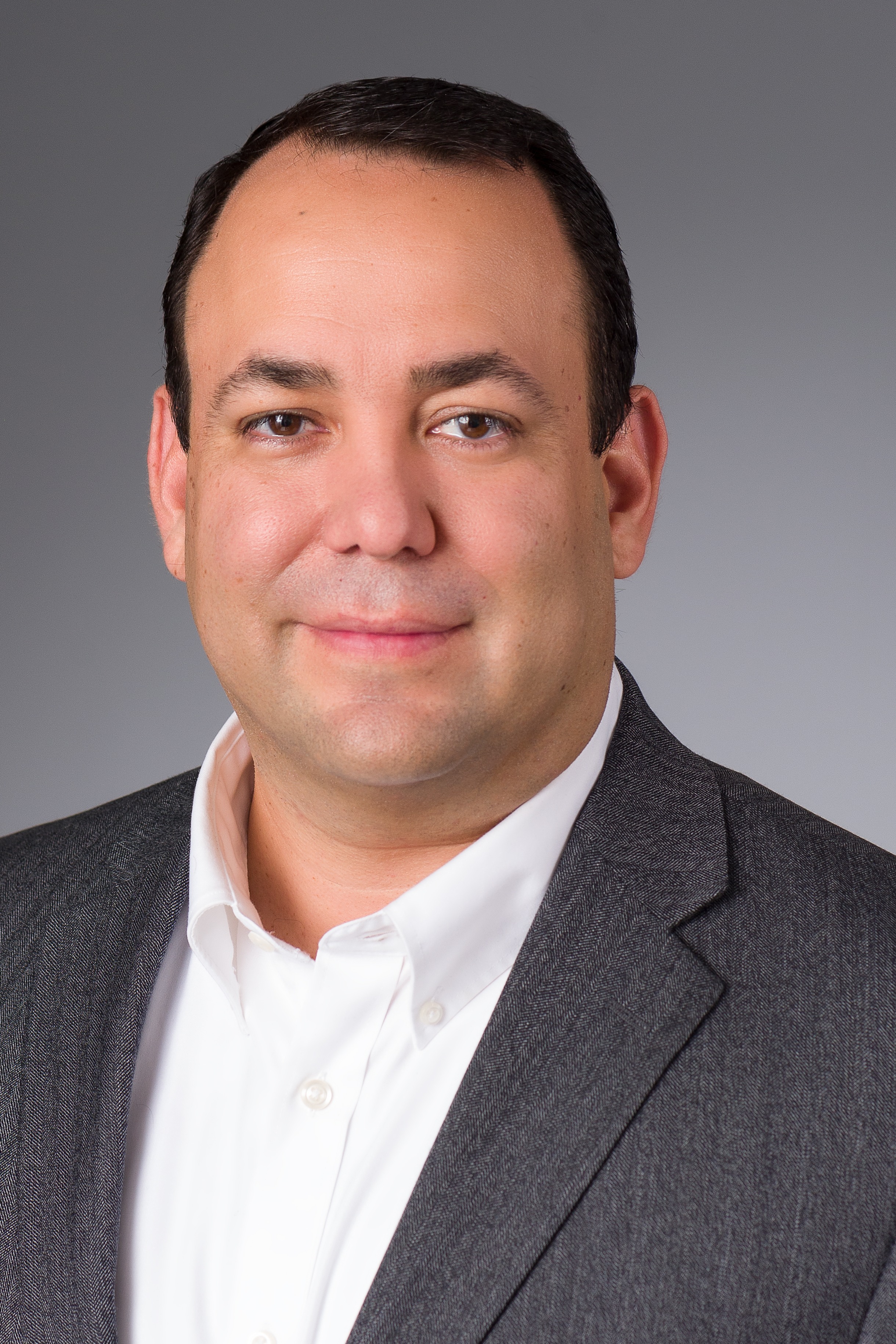 Eden CFO Ivan Garcia smiles in suit jacket.